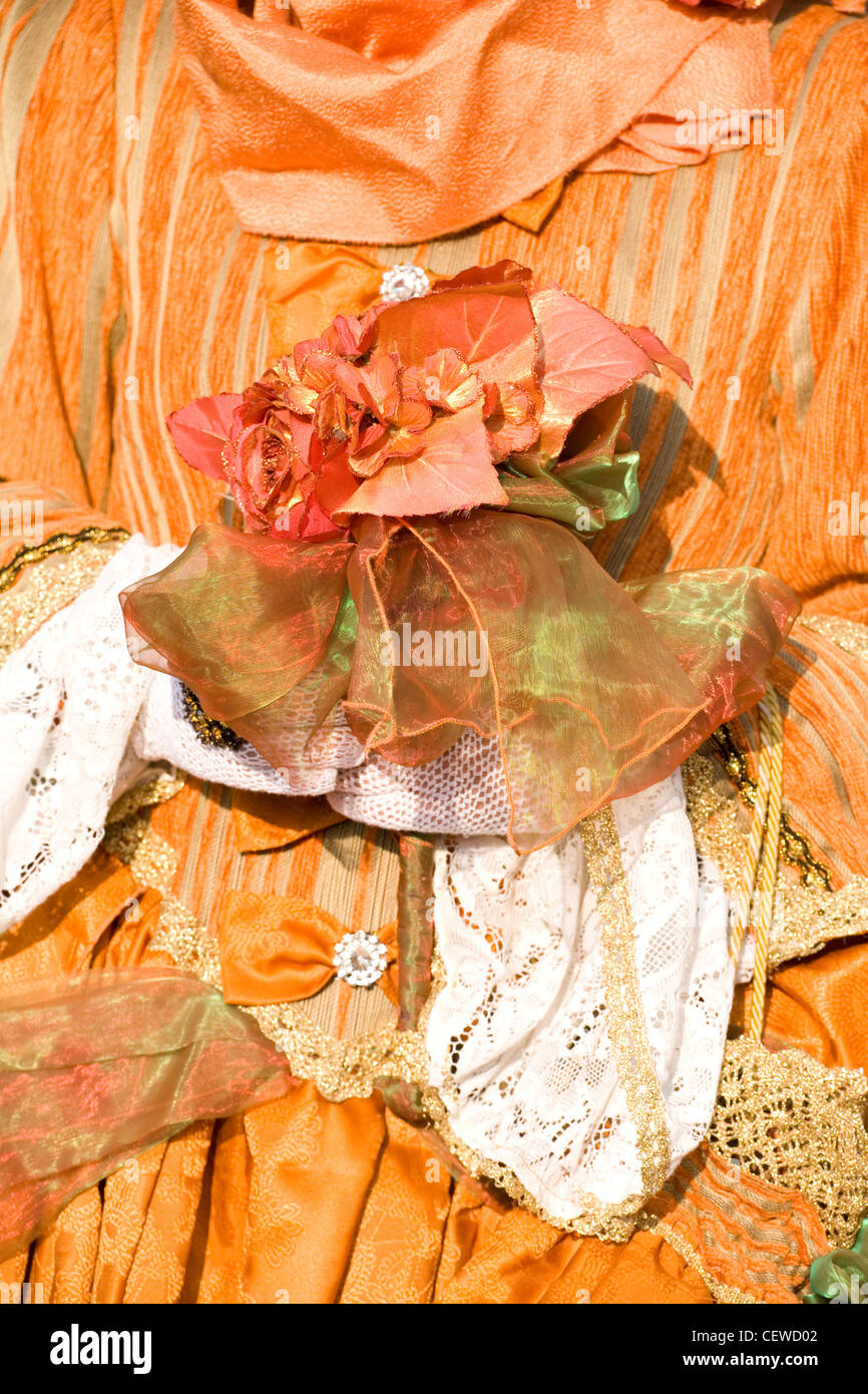 Orange Fancy dress women holding a flower Stock Photo Alamy