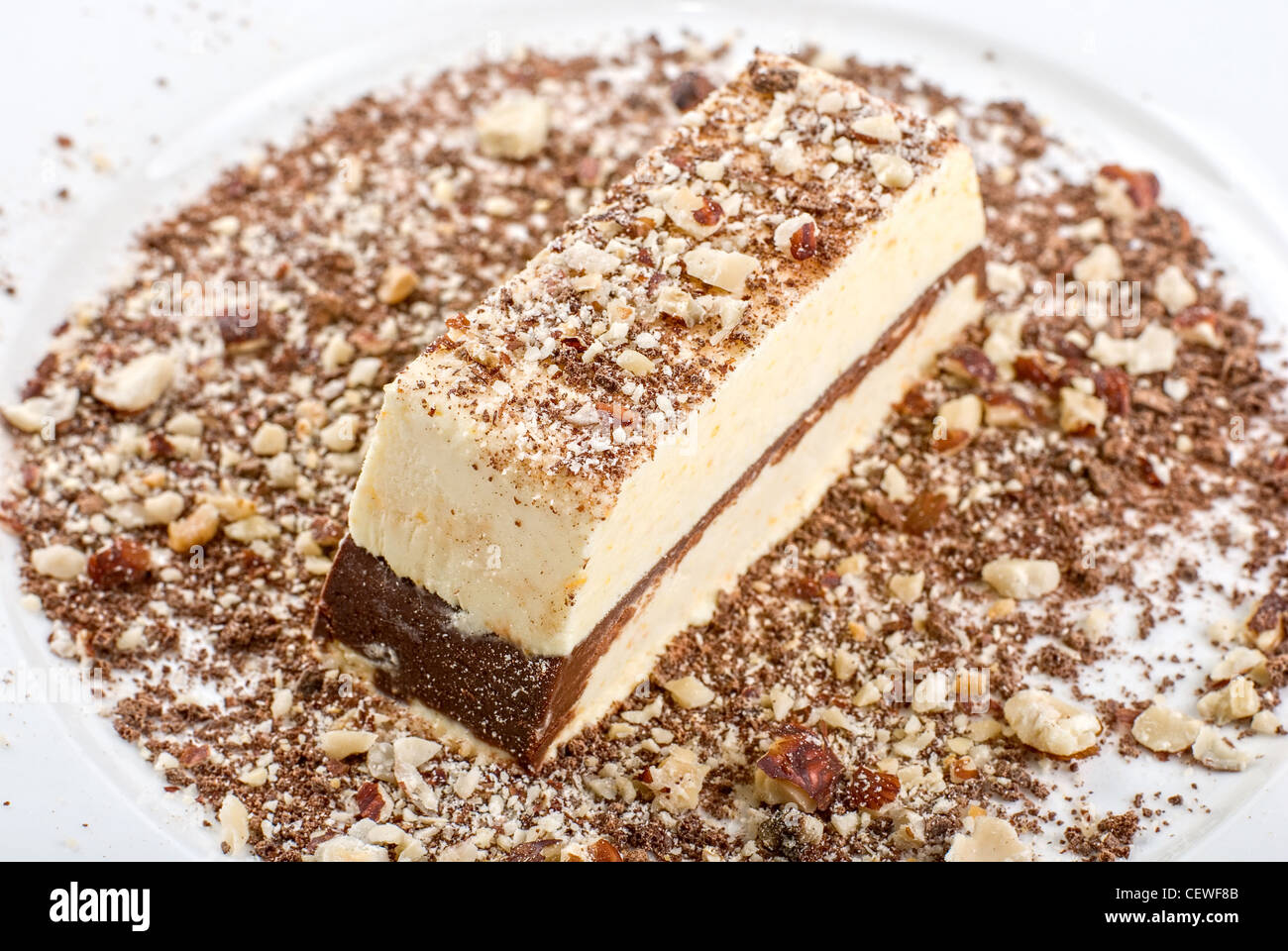 Slice of chocolate cake with nuts isolated on white Stock Photo - Alamy
