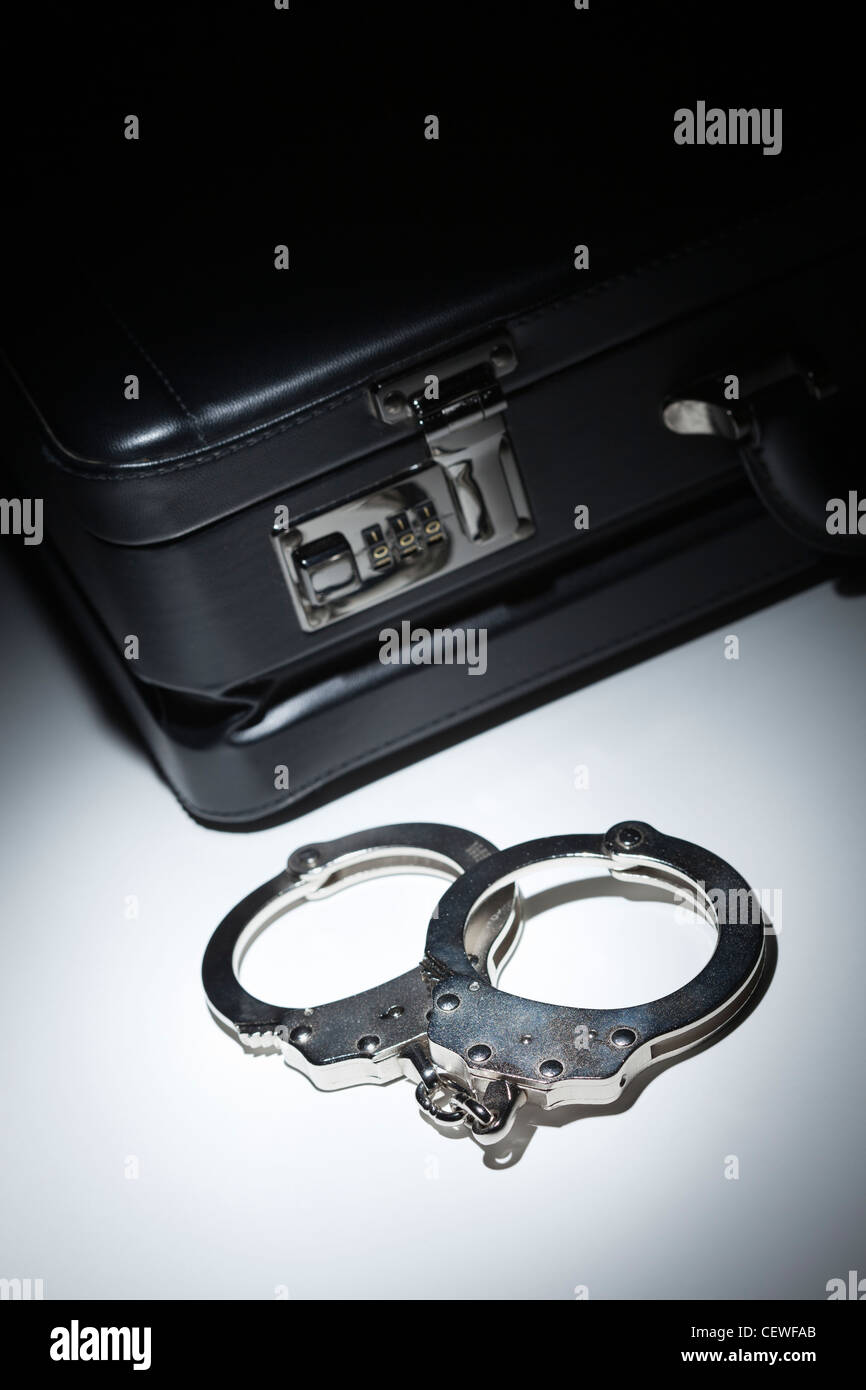 Pair of Handcuffs and Briefcase Under Spot Light Abstract Stock Photo Alamy