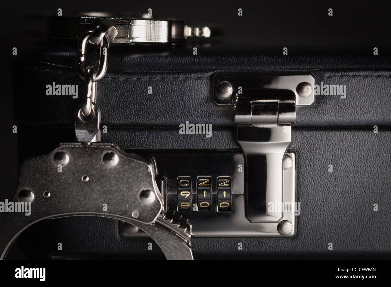 Pair of Handcuffs on Briefcase with the Numbers 911 on Lock Stock Photo