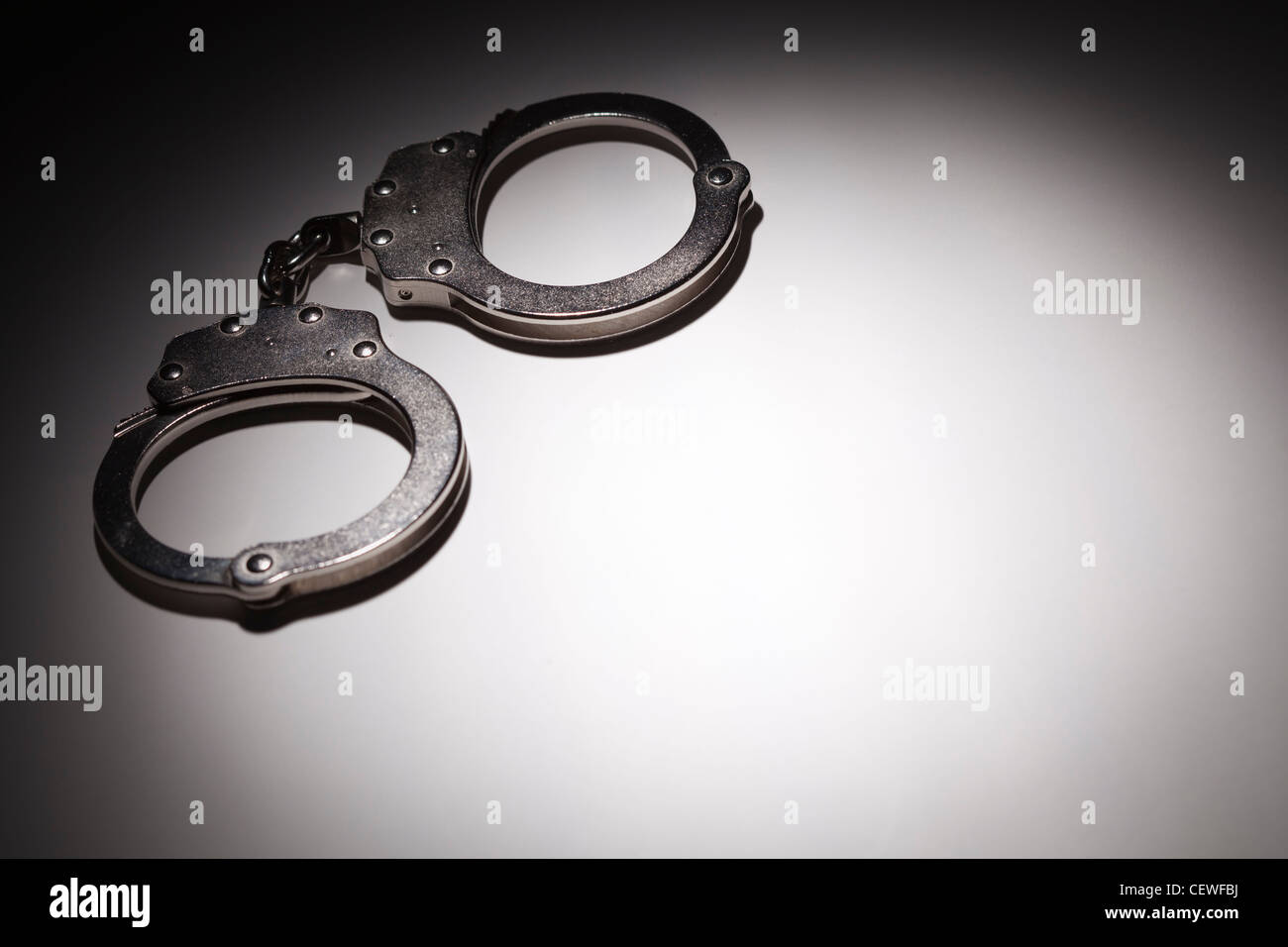 Abstract Pair of Handcuffs Under Spot Light With Room For Your Own Text