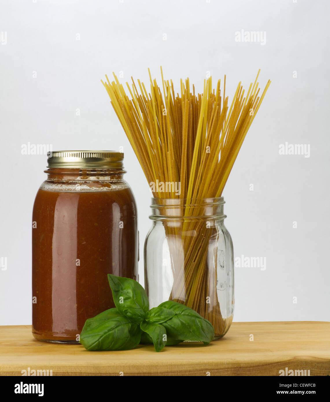 Fresh basil homemade tomato sauce and spaghetti pasta in a mason jar