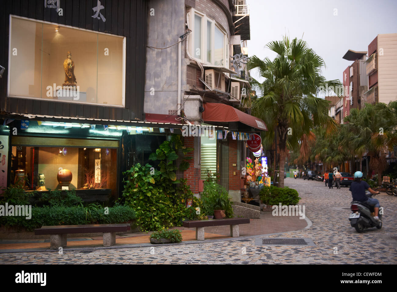 A Daoist God Guan Yin on display in a store's window overlooking a popular street in Yingge. Stock Photo