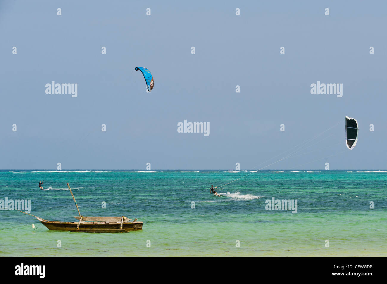 Kite surfers and traditional boat at Bwejuu east coast of Zanzibar Tanzania Stock Photo