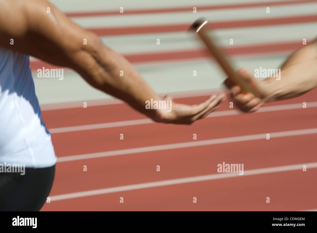 Runners exchanging baton in relay race, cropped Stock Photo Alamy