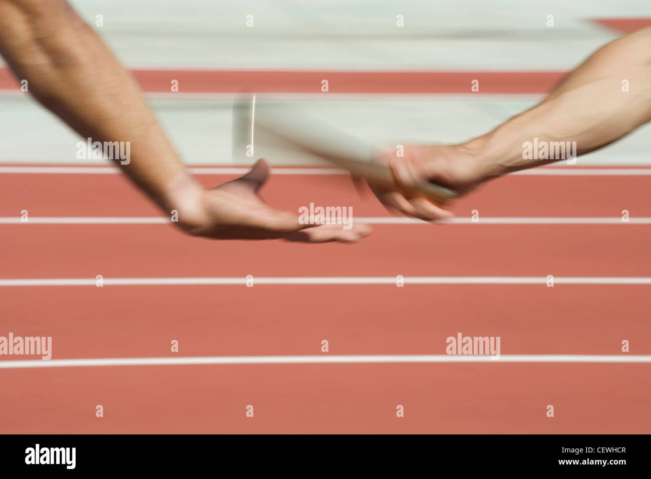 Runners exchanging baton in relay race, cropped Stock Photo Alamy