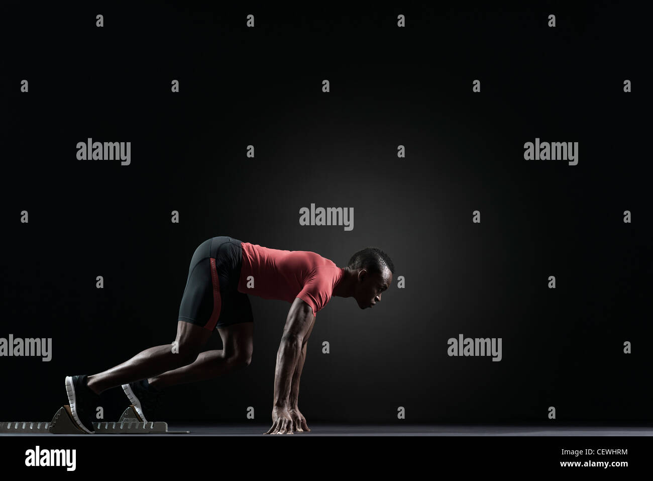 Male athlete on starting block Stock Photo