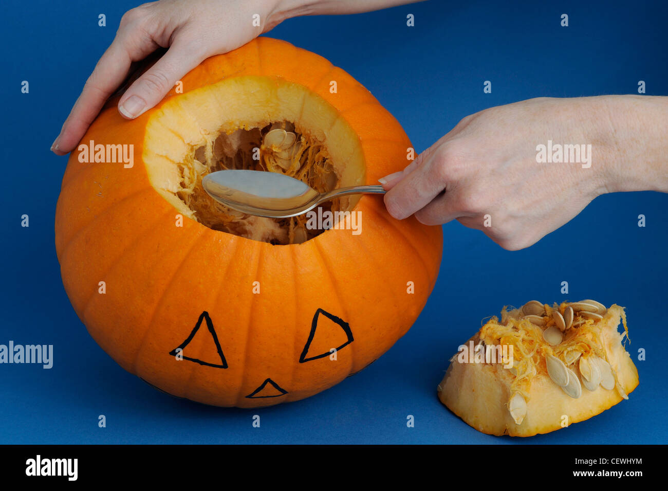 Pumpkin CarvingStepbyStepStep Scoop out the seeds Stock Photo Alamy
