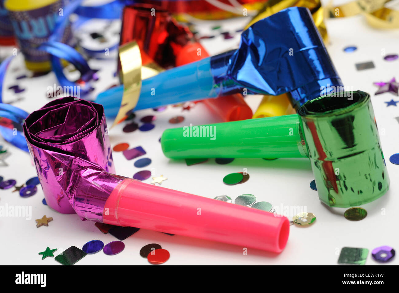 A still life image of colourful confetti, horn blowers and streamers on