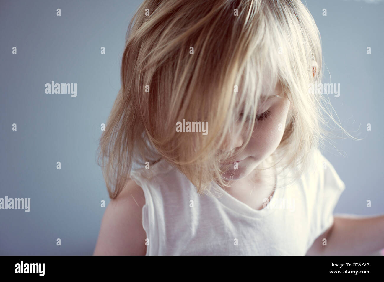 Little girl looking down, hair covering face Stock Photo Alamy