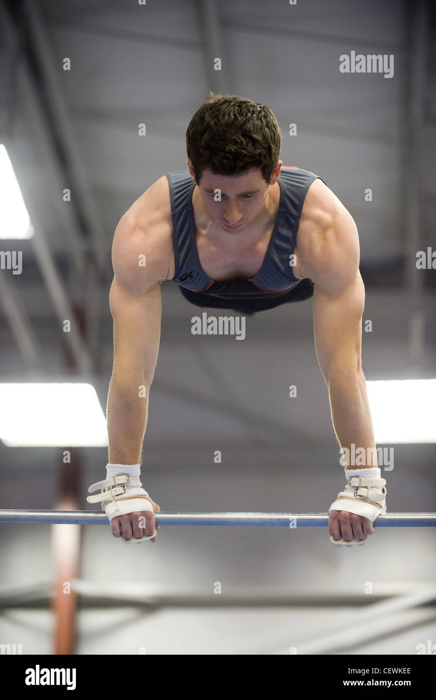 Male gymnast on horizontal bar Stock Photo