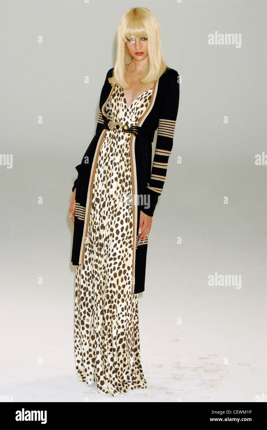 Blonde female model wearing a flolength leopard print dress a long black,  white and beige striped cardigan a decorative belt Stock Photo - Alamy