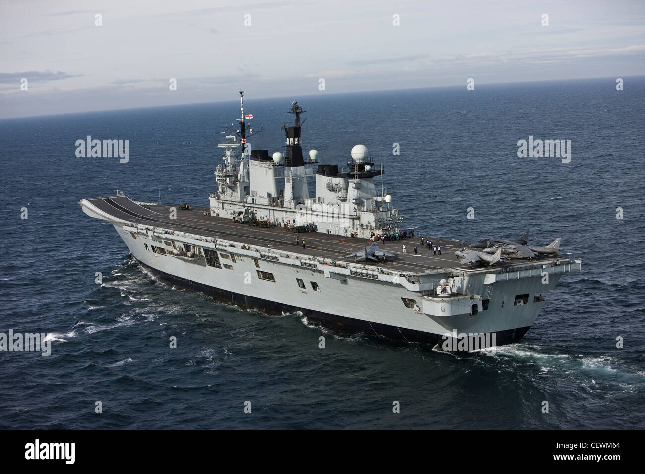 Naval aircraft carrier HMS Illustrious with crew and Harrier Jets Stock Photo