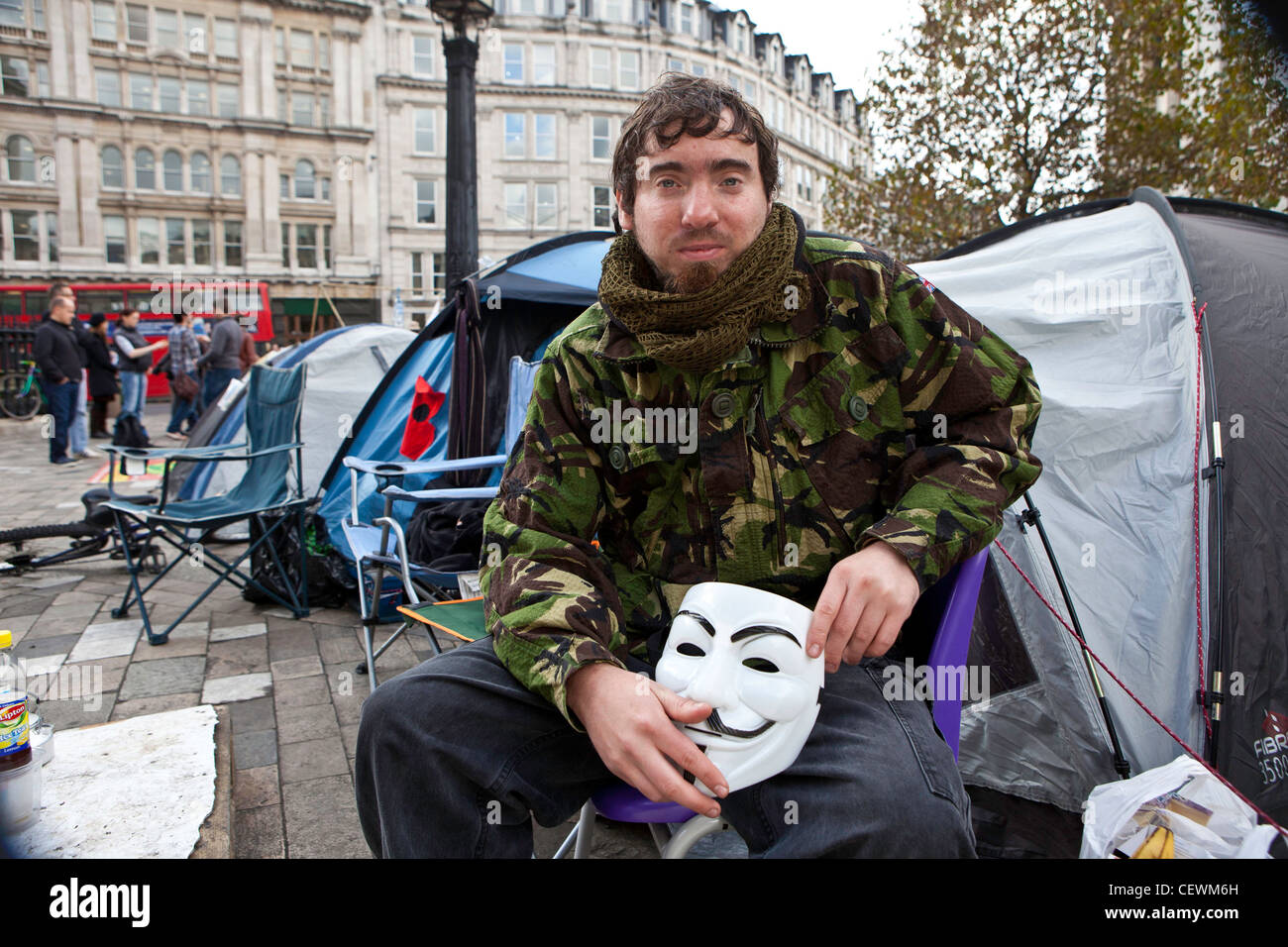 Tristan Woods protester at Occupy London OSLX protest sitting outside his tent. Stock Photo