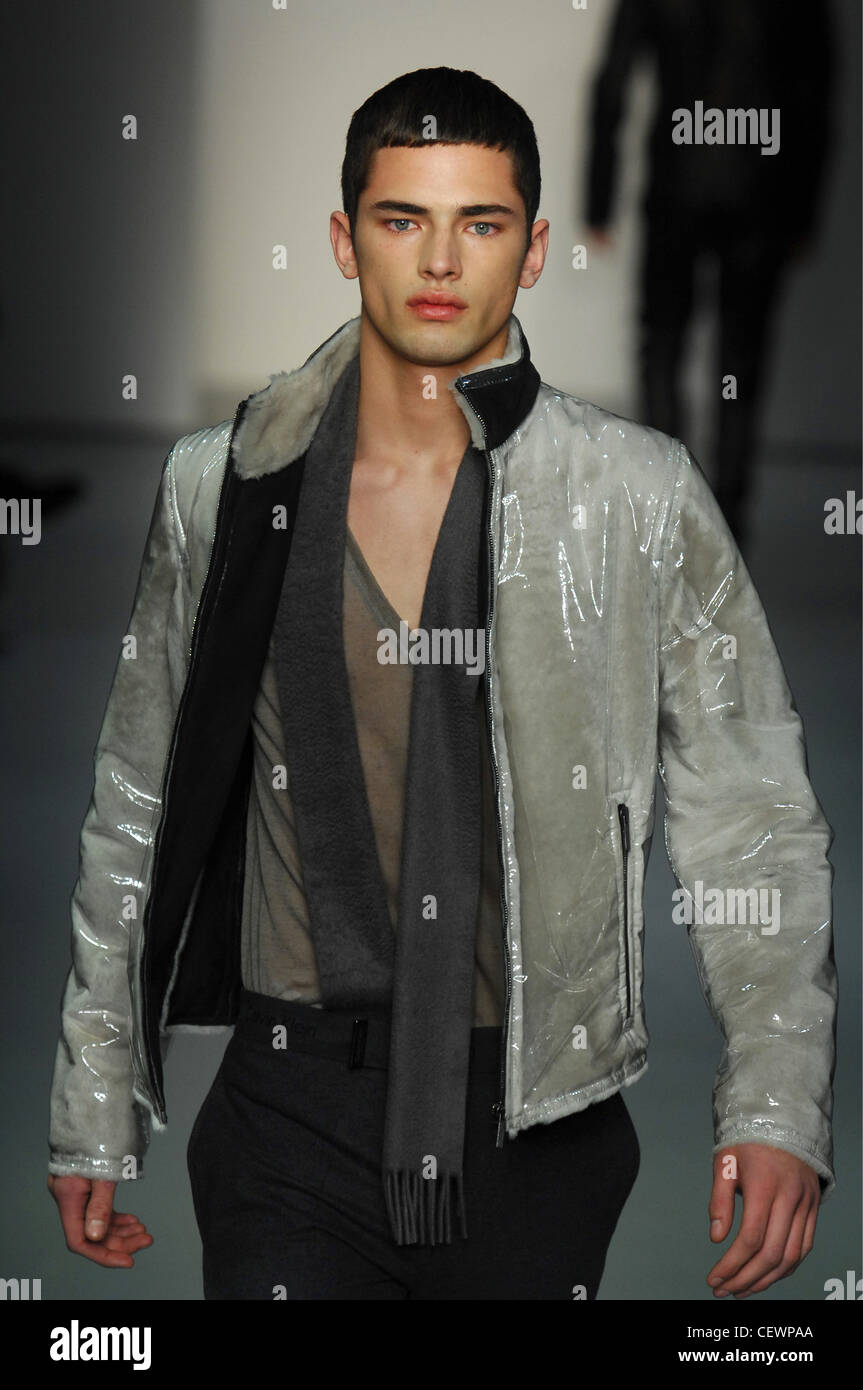 Calvin Klein Milan Menswear Ready to Wear Autumn Winter Gradient Grey  Tones: male model wearing clear perspex grey shiny Stock Photo - Alamy