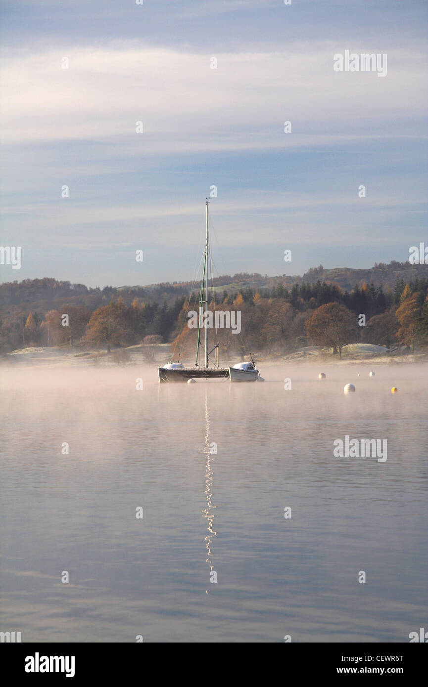 A lone catamaran on Lake Windemere. Stock Photo