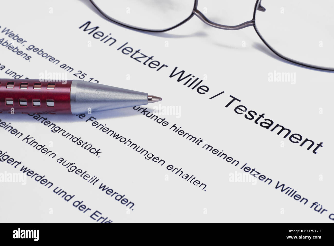 Detail photo of a testament, alongside are a pen and a glasses Stock Photo