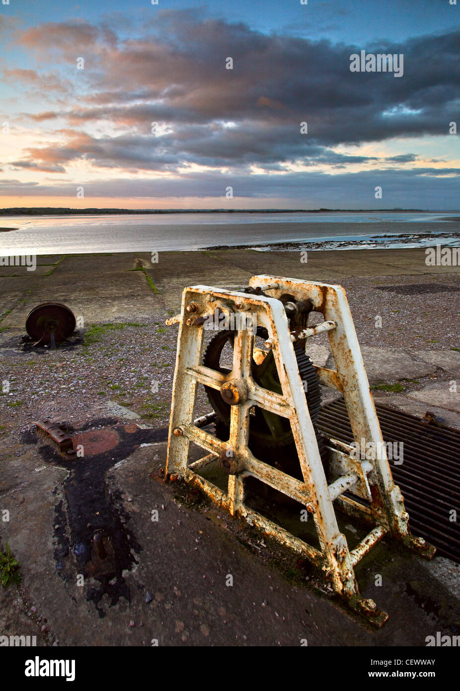 Redundant loch gate winding mechanism with the river Severn in the background. The canal and lock basins were built by the Sever Stock Photo