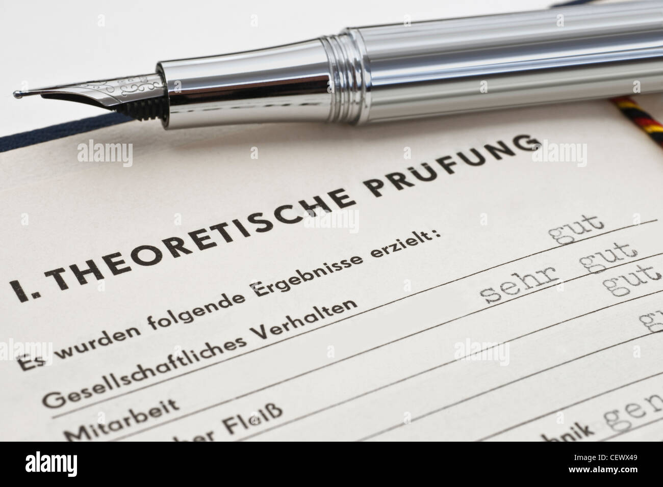 GDR craft certificate from 1954, the page of the theoretical test is opened, a fountain pen is alongside Stock Photo