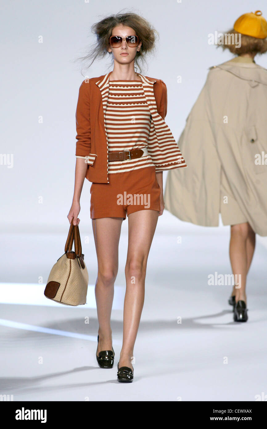 Brown Tones: Two piece shorts suit and matching striped top, belt, brown shades, handbag and patent loafers Stock Photo