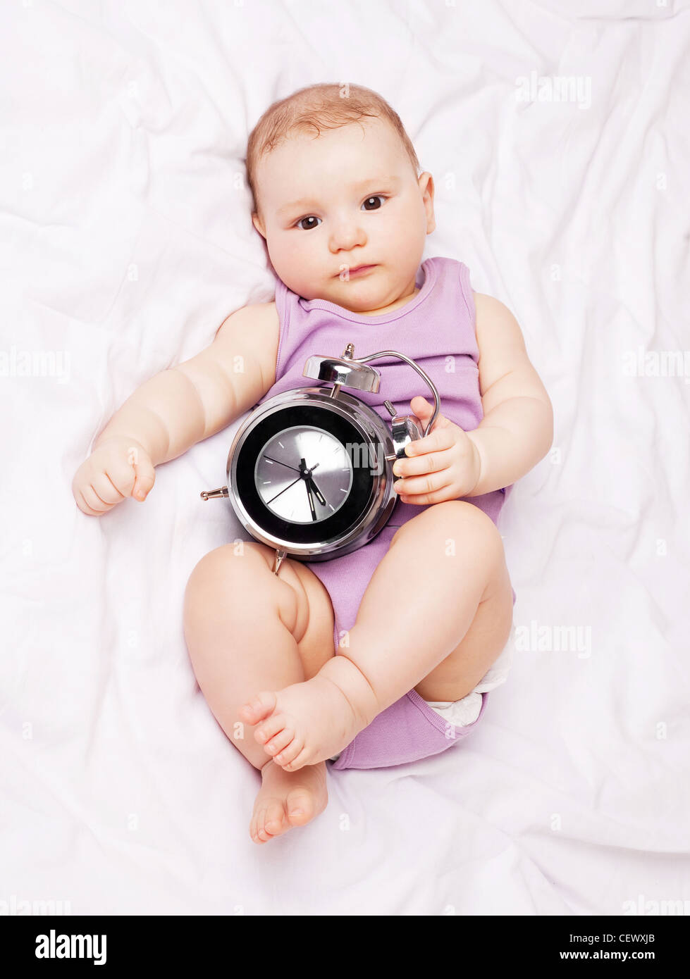 baby with alarm clock Stock Photo Alamy
