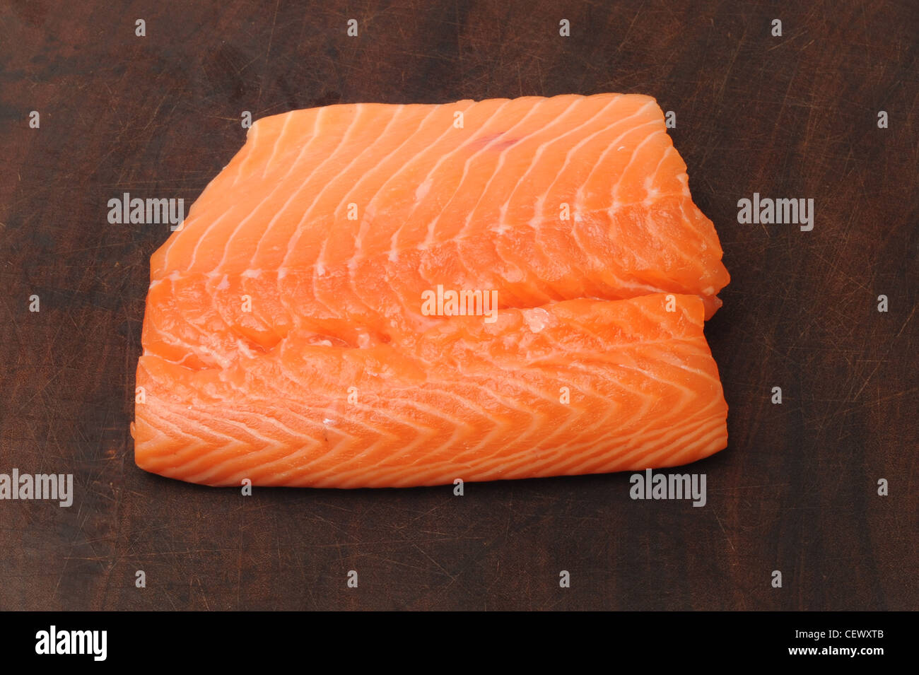 salmon fillet on a dark wood background Stock Photo - Alamy