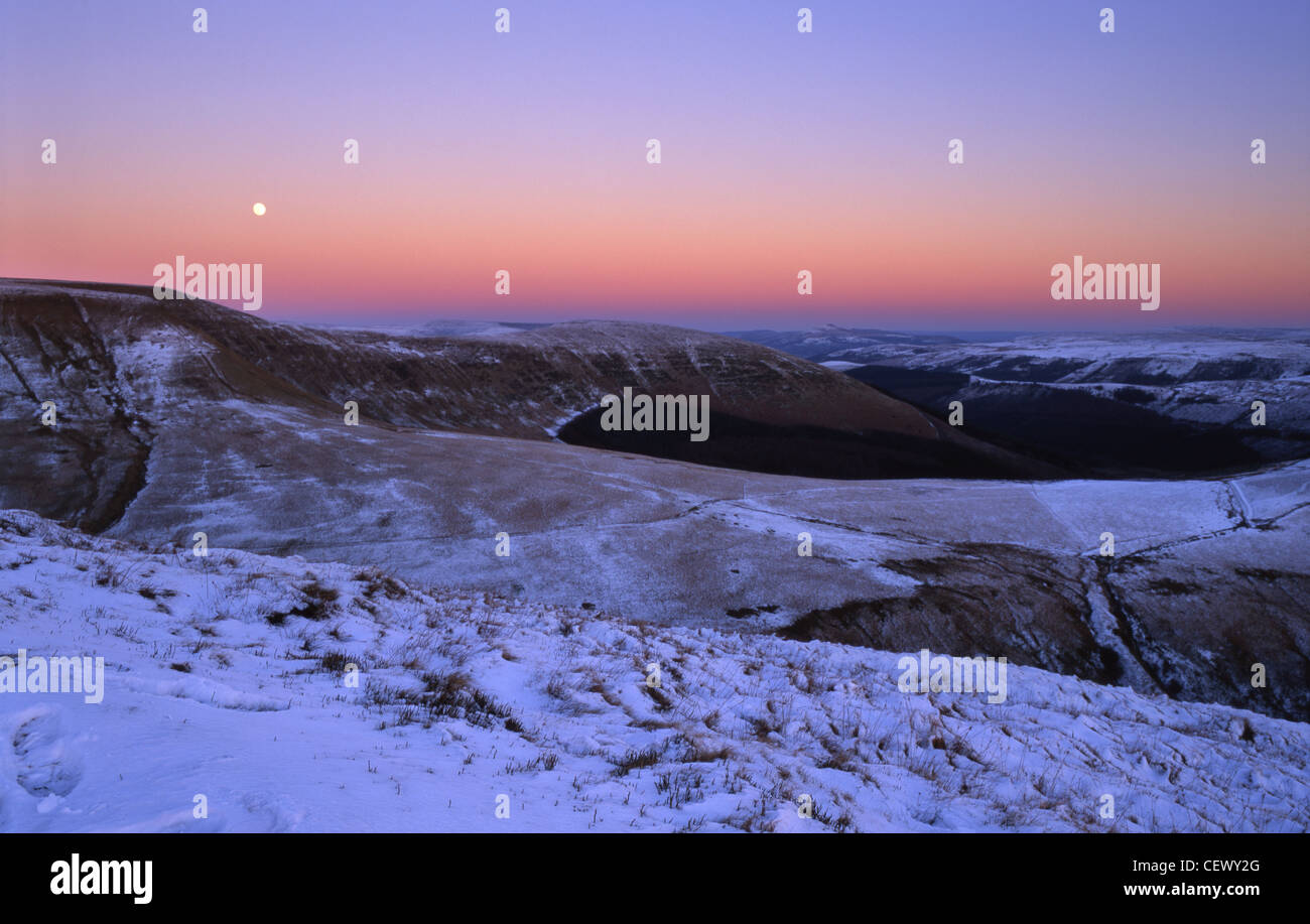 A dawn sky over a snow covered Craig Y Fan Ddu near Merthyr Tydfil. Stock Photo