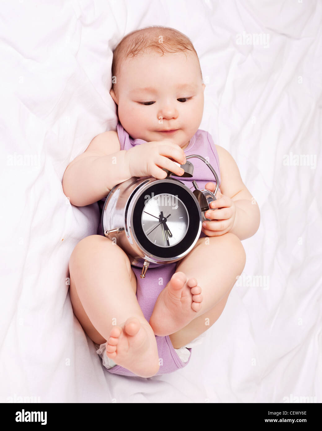 baby with alarm clock Stock Photo Alamy