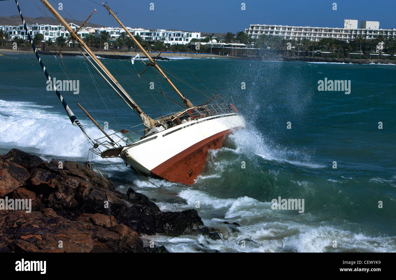 yacht crash on the rocks in stormy weather Stock Photo