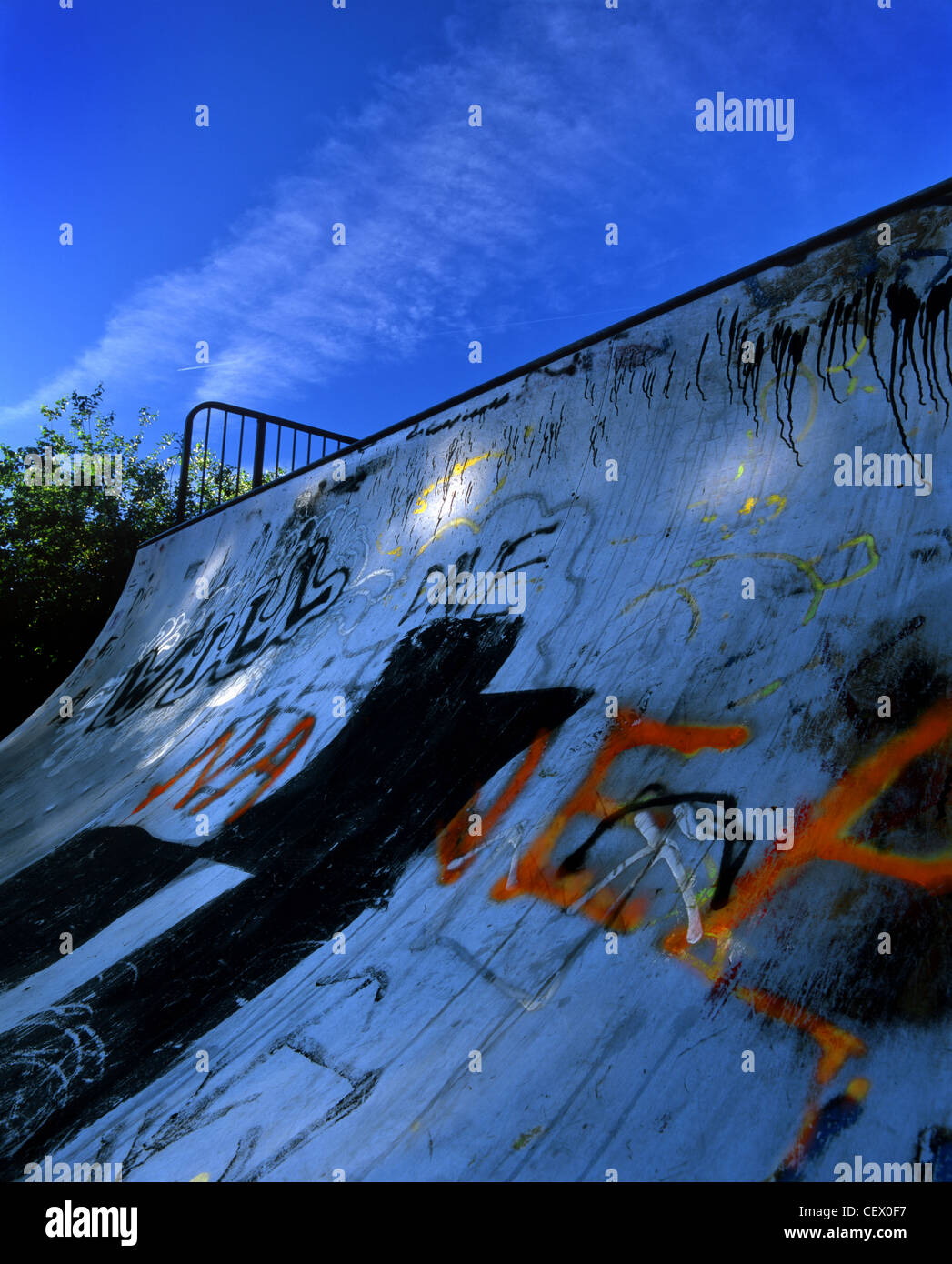 A skateboard ramp covered in graffiti. Stock Photo