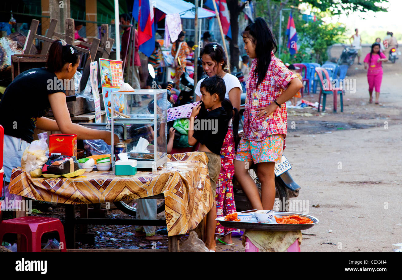 Children buying food from a street vendor in Kratie, Cambodia Stock