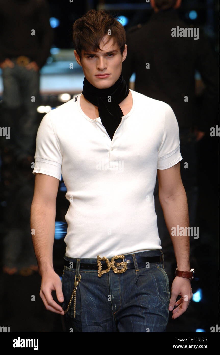 Dolce and Gabbana Menswear Milan A W Brunette male a white T shirt into dark wash jeans a black leather Photo - Alamy
