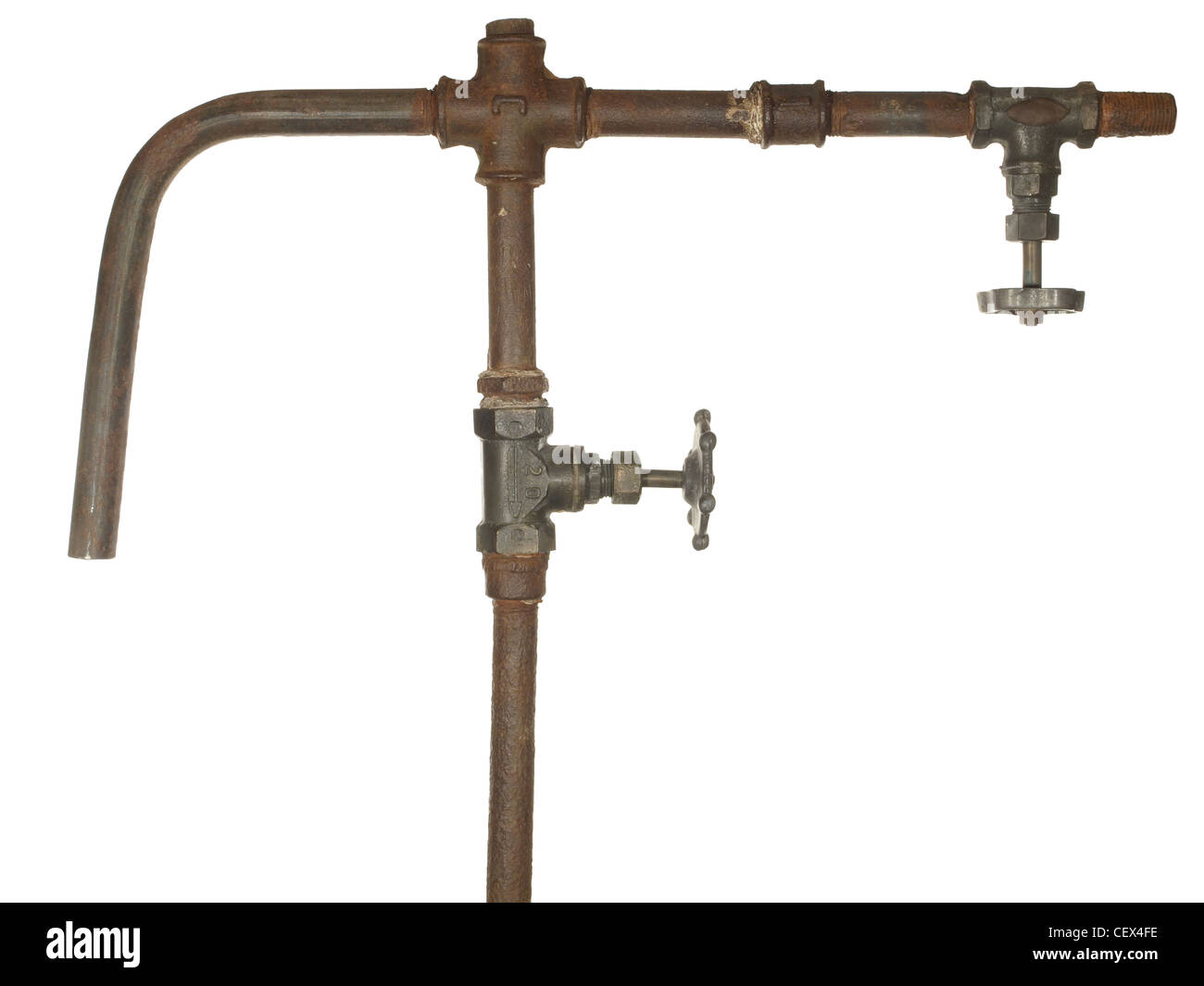 A fragment of the old water conduit consisting of pipes, fittings and valve Stock Photo