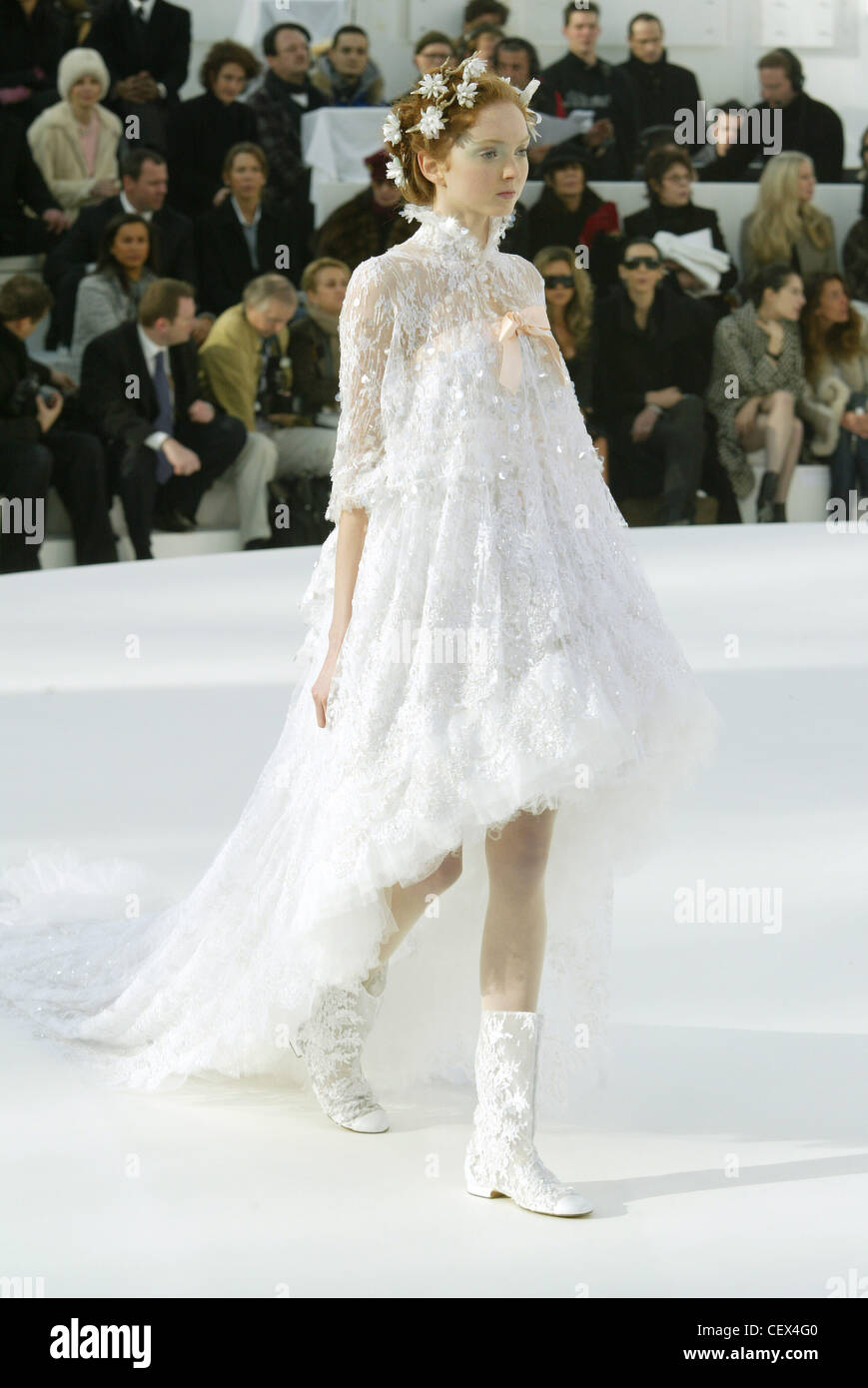 Haute Couture Chanel Spring Summer Paris British model Lily Cole wearing a white  lace trapeze dress train floating several feet Stock Photo - Alamy