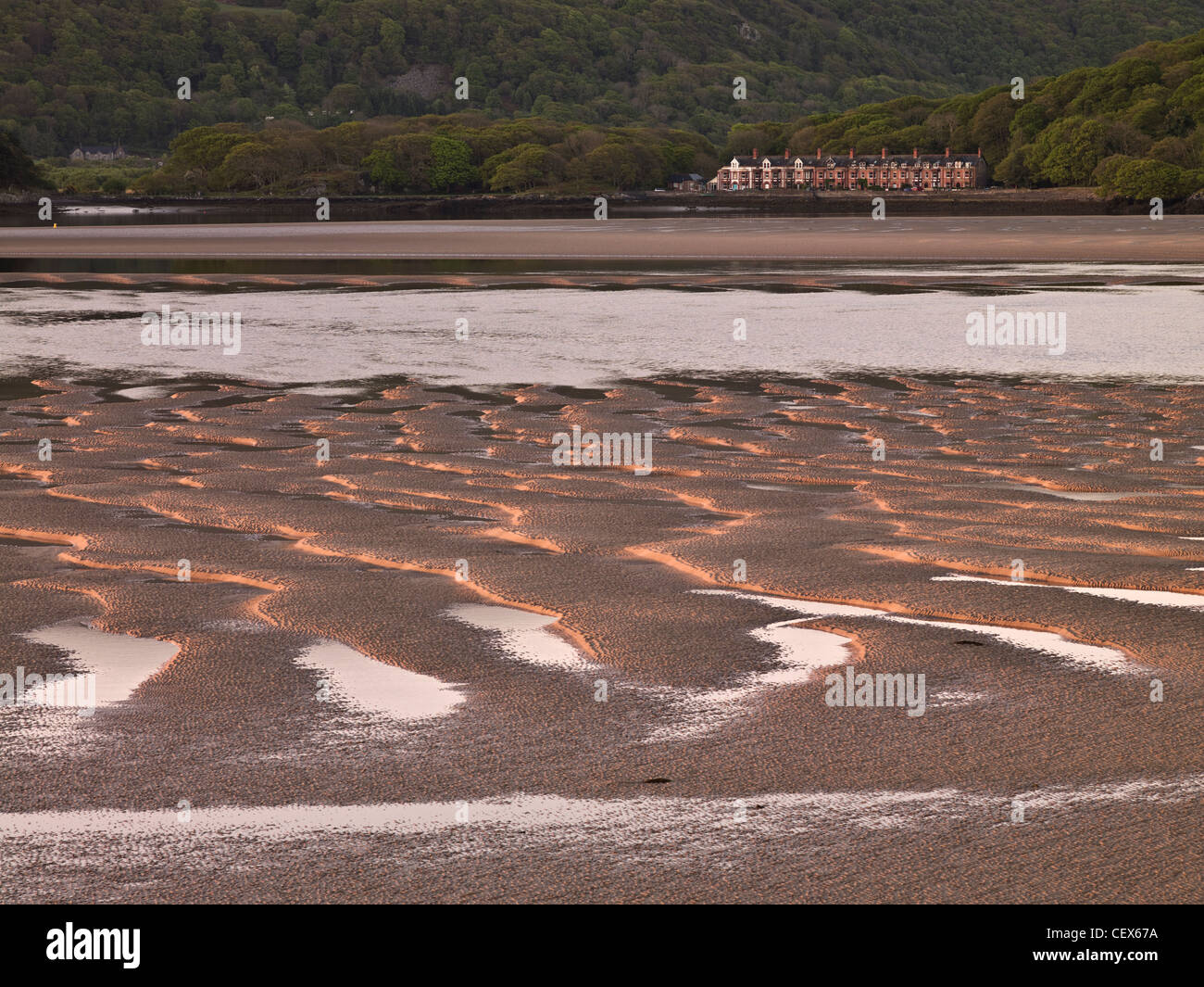 Mawddach Estuary at low tide with a terrace of cottages in the distance. Stock Photo