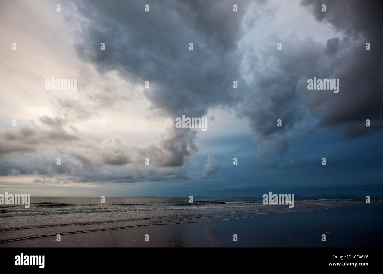 A storm cloud gathering over Barmouth beach at dusk. Stock Photo