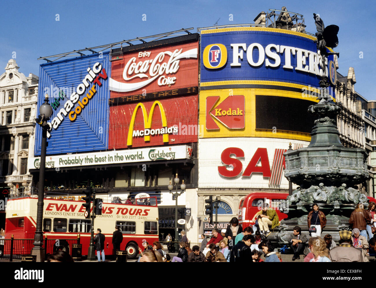 Piccadilly Circus, Eros statue, London England UK English tourism visitors tourists advertising hoarding hoardings open top bus Stock Photo