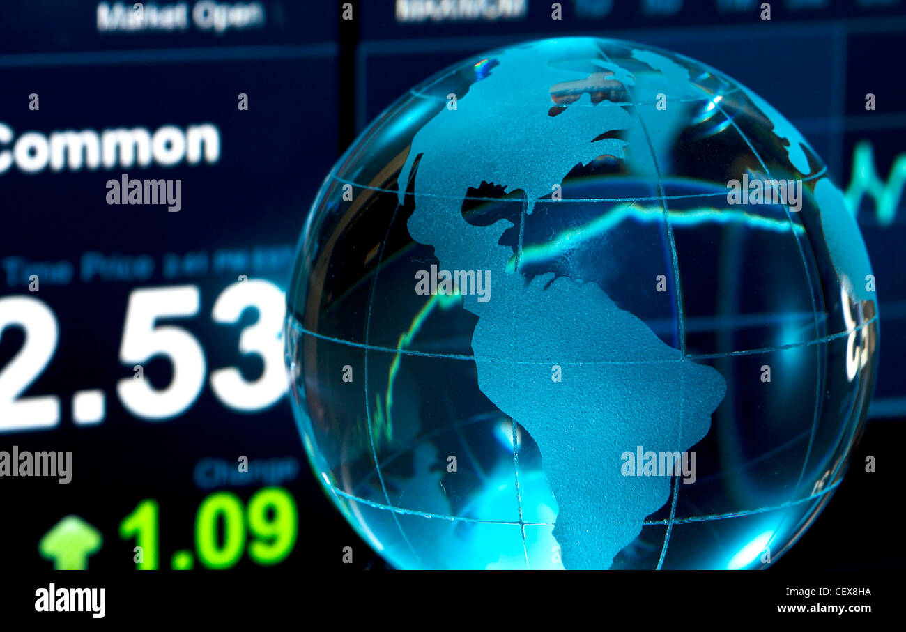 Glass globe over stock data on computer screen Stock Photo