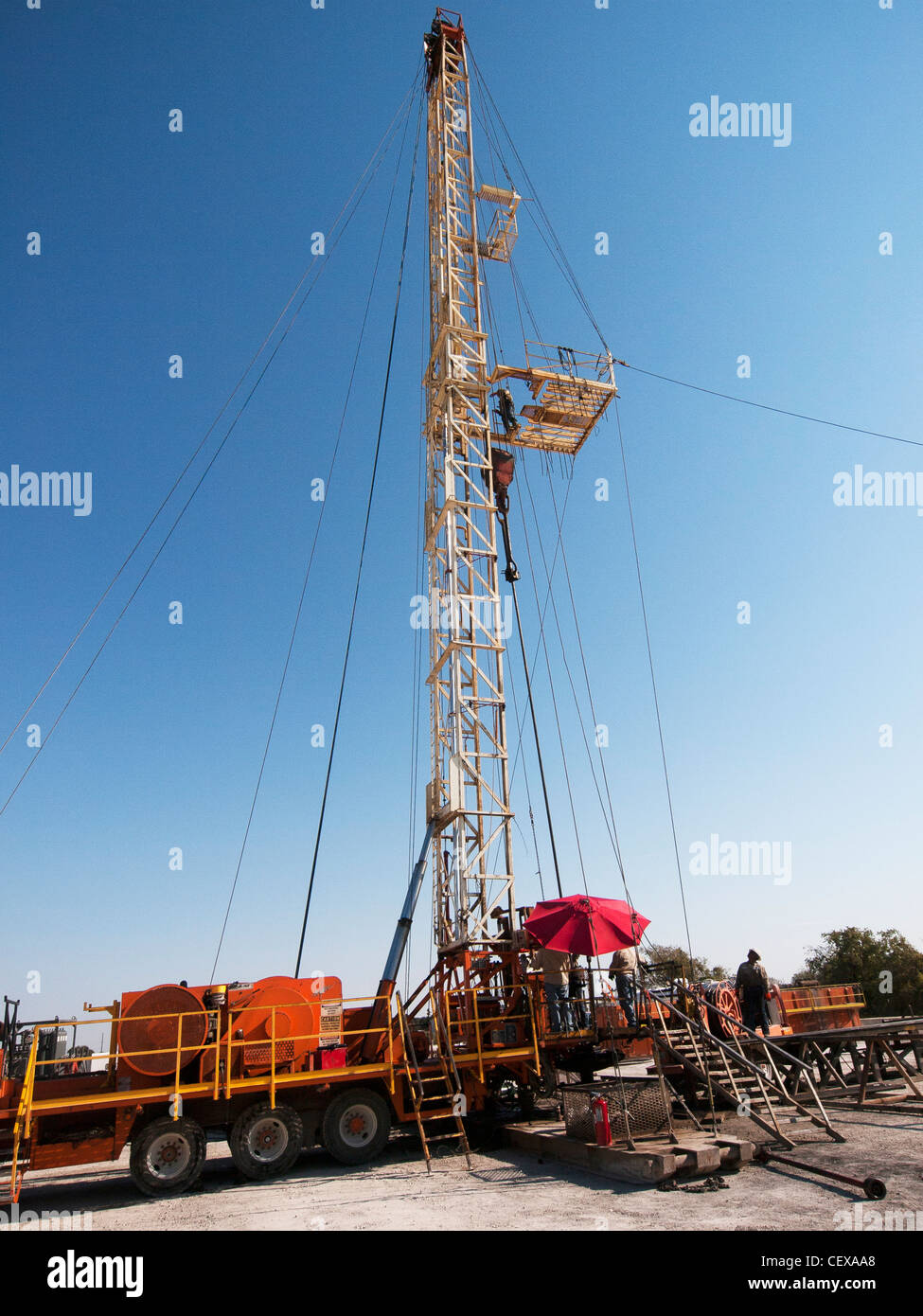 Roughneck on a mobile drilling rig, pulls pipe from well. Stock Photo