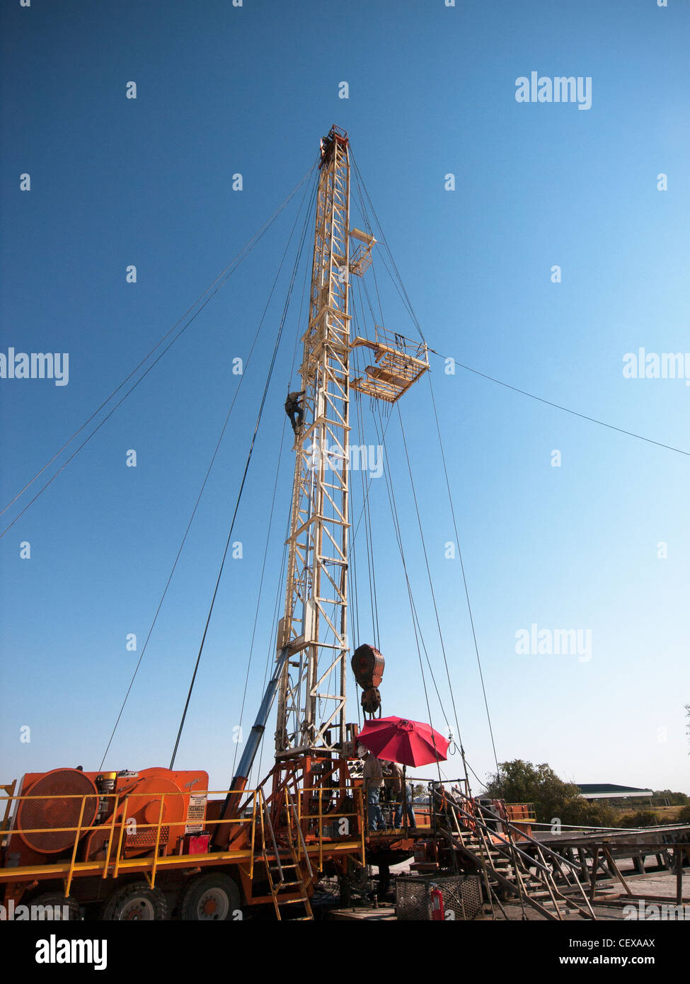 Worker climbs down mobile rig after helping push pipe down the well. Photos by J.G. Domke - jim.domke@gmail.com Stock Photo