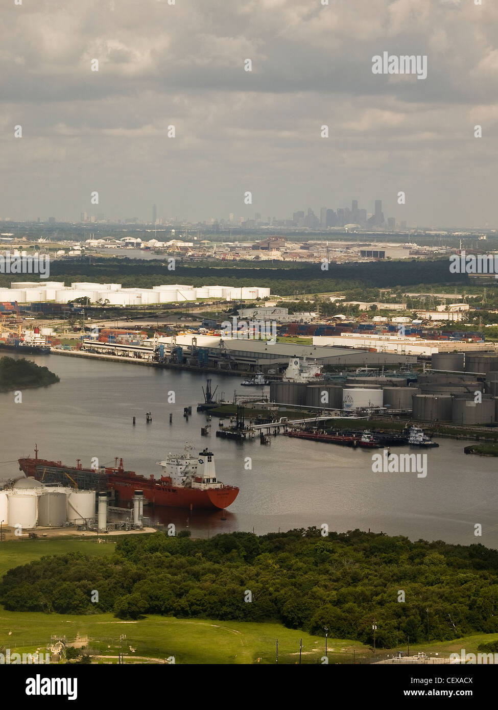 Fuel tanker in bayou along Port of Houston with Houston skyline in the