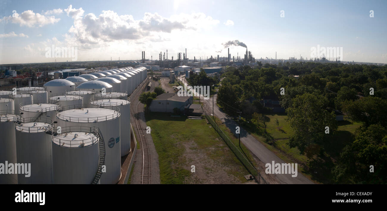 Pipes tower up in the background near the port of Houston where ships bring imported oil and export fuels around the world. Stock Photo