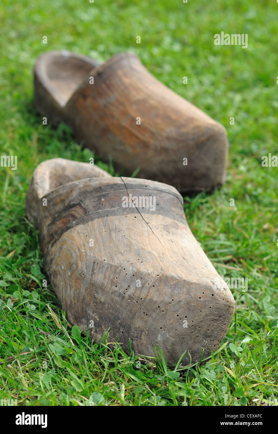 Two old Dutch clogs on the grass. Stock Photo