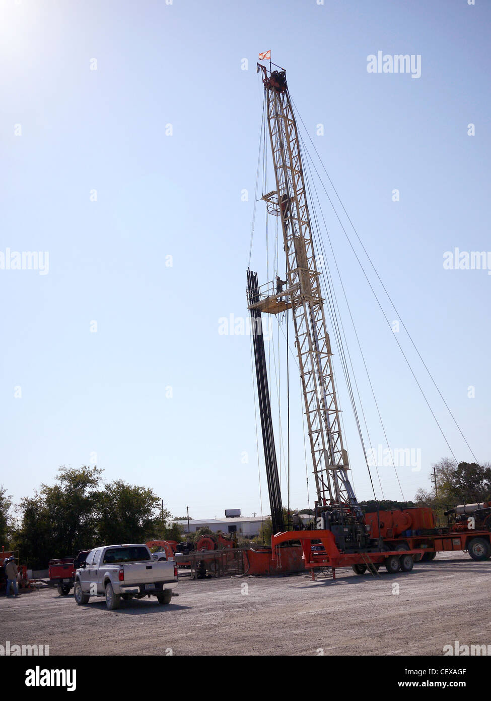 Drilling pipe gets pulled from well by a mobile drilling rig at a site neat Ft Worth Texas, USA Stock Photo