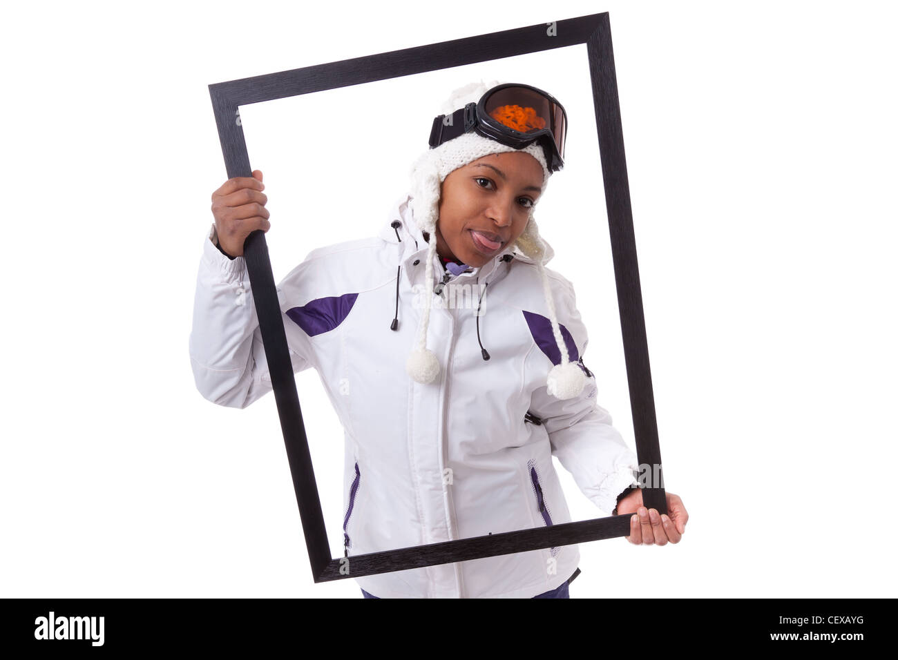 Young african woman in ski clothes holding a picture frame, isolated on