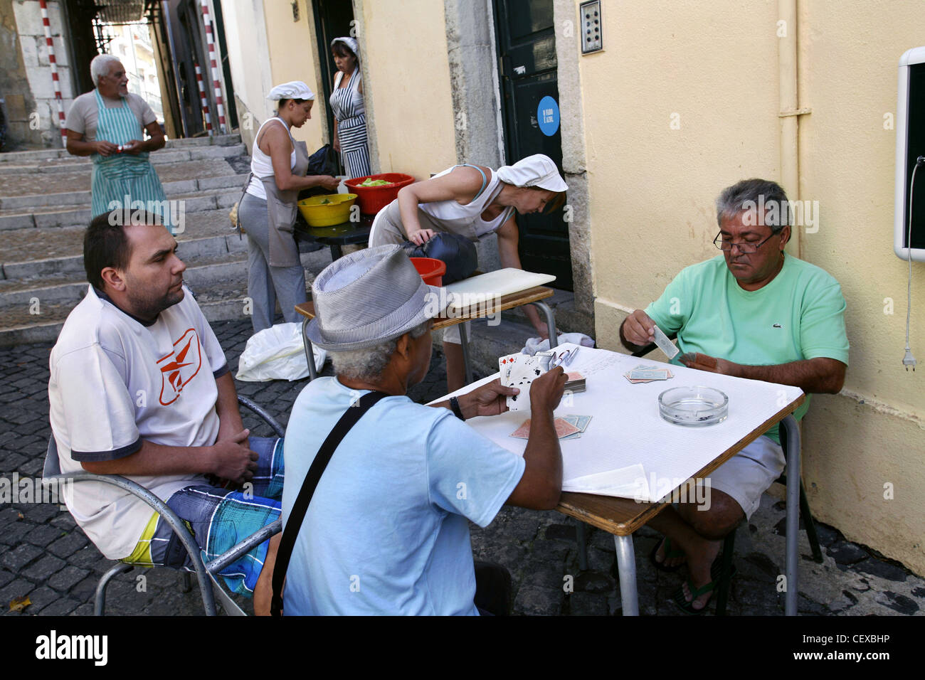 Kitchen Staff and Locals in Alfama District, game of cards, Lisbon, Portugal Stock Photo