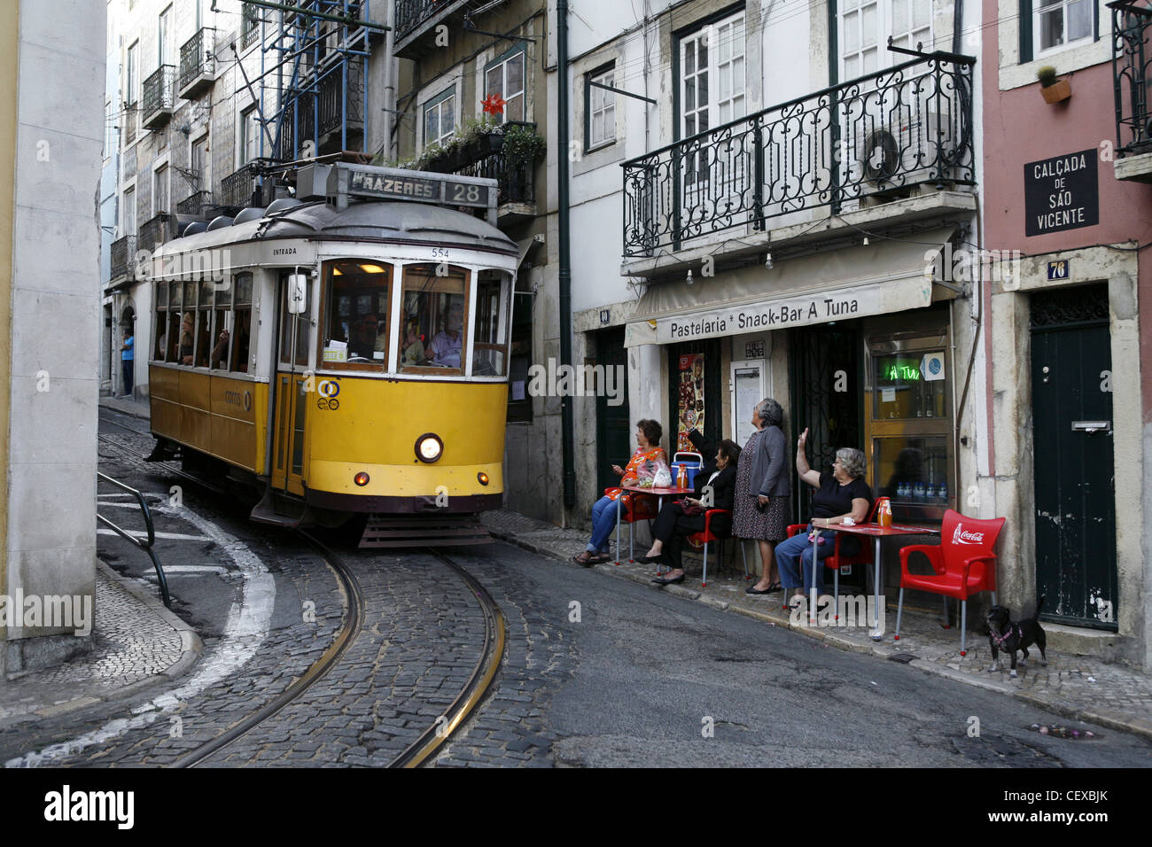 Greeting the Driver of Tram No. 28 in Alfama, Lisbon, Portugal Stock Photo