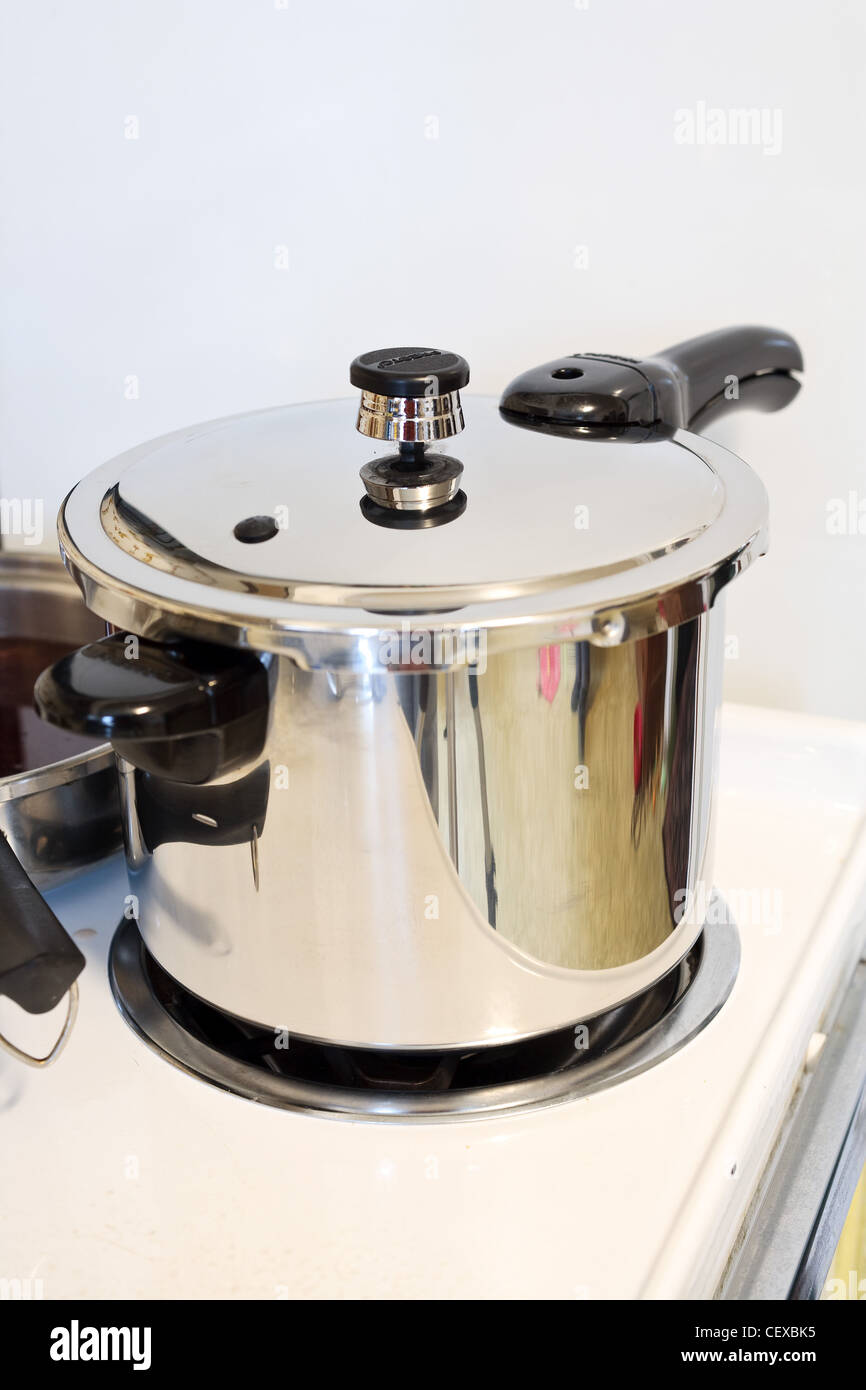 A pressure cooker/ pot on a stove Stock Photo Alamy