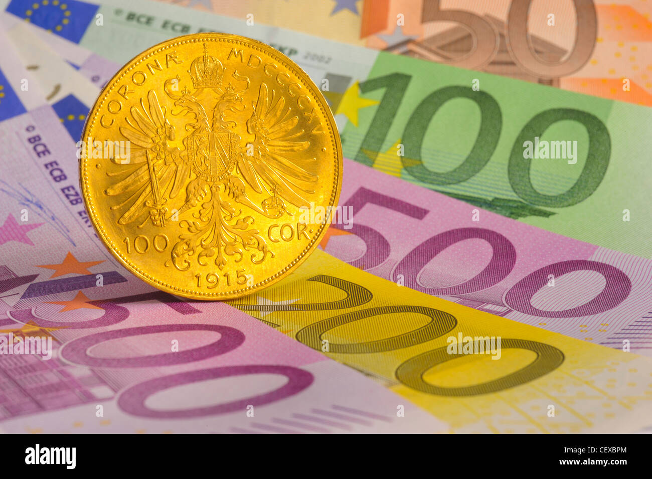 antique gold coin and euro banknotes Stock Photo