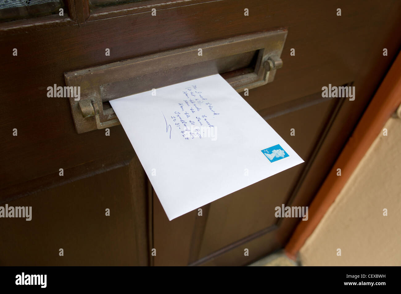 second class mail in a letter box, uk Stock Photo